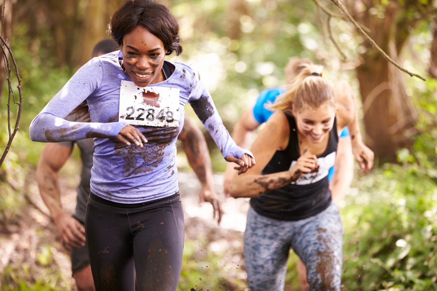 Two women running in a forest at an endurance event