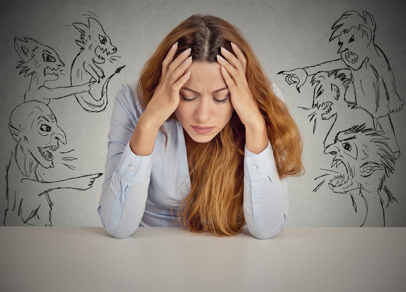 Desperate young businesswoman sitting at desk in her office Desperate young businesswoman sitting at desk in her office